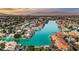 Breathtaking aerial view of luxury waterfront homes surrounding a serene blue lake at 9005 Feather River Ct, Las Vegas, NV 89117