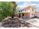 Home's backyard featuring covered patio and mature trees at 9005 Feather River Ct, Las Vegas, NV 89117