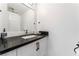 Updated bathroom with black countertop and white cabinets at 9005 Feather River Ct, Las Vegas, NV 89117