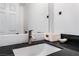 Bathroom vanity with black countertop and white cabinets at 9005 Feather River Ct, Las Vegas, NV 89117