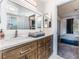 Bathroom with wooden cabinets and an ensuite bedroom at 9005 Feather River Ct, Las Vegas, NV 89117
