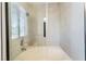 Modern tub and shower with glass door and bright natural light at 9005 Feather River Ct, Las Vegas, NV 89117
