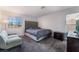 Cozy bedroom with plush carpet, windows for light, and a comfortable futon at 9005 Feather River Ct, Las Vegas, NV 89117