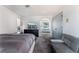 Relaxing bedroom featuring a TV, large bed, and a comfortable gray futon at 9005 Feather River Ct, Las Vegas, NV 89117