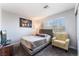Bedroom with a large window, carpeted floor, and comfortable furniture at 9005 Feather River Ct, Las Vegas, NV 89117