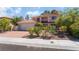 Lovely two-story home featuring lush front yard landscaping and a spacious two-car garage at 9005 Feather River Ct, Las Vegas, NV 89117
