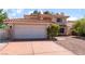 Charming two-story home with a red tile roof, manicured landscaping, and a two-car garage at 9005 Feather River Ct, Las Vegas, NV 89117