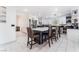 Modern kitchen boasts white cabinets, stainless steel appliances, large island with counter seating, and stylish tile flooring at 9005 Feather River Ct, Las Vegas, NV 89117