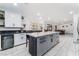 Modern kitchen with a central island, white cabinets, and stainless steel wine cooler at 9005 Feather River Ct, Las Vegas, NV 89117