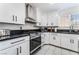 Stylish kitchen showcasing white cabinets, black countertops, and stainless steel appliances for modern cooking at 9005 Feather River Ct, Las Vegas, NV 89117