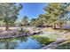 Picturesque community pond with rocks and landscaping at 9005 Feather River Ct, Las Vegas, NV 89117