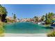 Beautiful waterfront community with stunning lake views and tropical landscaping at 9005 Feather River Ct, Las Vegas, NV 89117