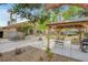 Expansive backyard featuring a covered patio, BBQ grill, and fire pit, perfect for outdoor entertaining at 950 Eagle Mountain Dr, Las Vegas, NV 89123