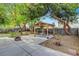 Backyard with a gazebo, dining table, grill, mature trees, and hardscape at 950 Eagle Mountain Dr, Las Vegas, NV 89123