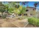 Beautiful backyard view featuring a covered patio, lush greenery, and serene landscaping at 950 Eagle Mountain Dr, Las Vegas, NV 89123
