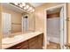 Bathroom with dual sink vanity, large mirror, and separate toilet/shower room at 950 Eagle Mountain Dr, Las Vegas, NV 89123