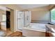 This bathroom features a soaking tub, glass shower, and walk-in closet at 950 Eagle Mountain Dr, Las Vegas, NV 89123