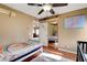 Bedroom with wood floors, ceiling fan, and view into another room at 950 Eagle Mountain Dr, Las Vegas, NV 89123