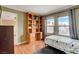Bright bedroom with built-in desk, storage, and a view of palm trees at 950 Eagle Mountain Dr, Las Vegas, NV 89123