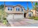 Charming two-story home with well-manicured landscaping and a three-car garage at 950 Eagle Mountain Dr, Las Vegas, NV 89123