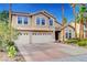 Charming two-story home with a three car garage, tile roof, and mature landscaping at 950 Eagle Mountain Dr, Las Vegas, NV 89123