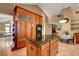 Bright eat-in kitchen features custom wood cabinetry, an island with granite countertops and tile flooring at 950 Eagle Mountain Dr, Las Vegas, NV 89123