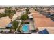Aerial view of a backyard oasis with a private swimming pool, lush greenery, and a covered patio at 9843 Frosty Canyon Ct, Las Vegas, NV 89183