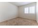 Neutral bedroom with carpet and a window with shutters at 9843 Frosty Canyon Ct, Las Vegas, NV 89183