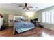 Large bedroom with hardwood floors, a ceiling fan, and built-in closet system at 9843 Frosty Canyon Ct, Las Vegas, NV 89183