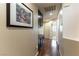 Hallway with hardwood floors and storage cabinets, featuring an accent painting at 9843 Frosty Canyon Ct, Las Vegas, NV 89183