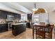 Modern kitchen features granite countertops, stainless steel appliances, dark cabinetry, and an island at 9843 Frosty Canyon Ct, Las Vegas, NV 89183