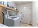 Functional laundry room with modern washer and dryer, and extra storage at 9843 Frosty Canyon Ct, Las Vegas, NV 89183
