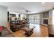 Open-concept living room with fireplace, dark cabinetry, and view to pool at 9843 Frosty Canyon Ct, Las Vegas, NV 89183