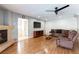 Spacious living room with a fireplace, hardwood floors, and neutral paint at 9843 Frosty Canyon Ct, Las Vegas, NV 89183