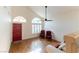 Spacious living room with wood floors, tall ceilings, and large windows with plantation shutters at 9843 Frosty Canyon Ct, Las Vegas, NV 89183