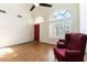 Bright living room features wood floors, soaring ceilings, and large windows with plantation shutters at 9843 Frosty Canyon Ct, Las Vegas, NV 89183