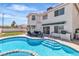 Backyard view of a pool, spa, outdoor kitchen and patio seating at 3604 N Campbell Rd, Las Vegas, NV 89129