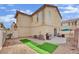 Well-maintained backyard with a small patio, artificial grass, and convenient access to the home at , Las Vegas, NV 89139