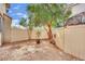 Secluded backyard with gravel landscaping, trees, and a wooden fence, perfect for low-maintenance outdoor living at , Las Vegas, NV 89139