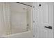 Bright bathroom with a tiled shower-tub combination and a white shower curtain at , Las Vegas, NV 89139
