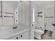 Bright bathroom with white vanity, sink, and toilet, with neutral decor and vinyl floors at , Las Vegas, NV 89139