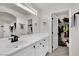 Bright bathroom with a long vanity and a view of a closet with clothes at , Las Vegas, NV 89139
