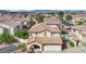 Two-story home with a terracotta tile roof, attached two-car garage, and drought-resistant landscaping at , Las Vegas, NV 89139