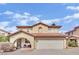 Two-story home featuring a red tile roof, arched entry, and a two-car garage against a sunny sky at , Las Vegas, NV 89139