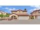 Two-story home featuring a red tile roof, arched entry, and a two-car garage against a sunny sky at , Las Vegas, NV 89139