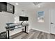 Well-lit home office with gray wood-look flooring, a black desk, and a comfortable workspace at , Las Vegas, NV 89139