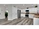 Bright kitchen with white cabinets, wood countertops, stainless steel appliances, and modern flooring at , Las Vegas, NV 89139