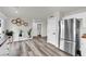 Open concept kitchen featuring stainless steel refrigerator, pantry, and modern gray vinyl flooring at , Las Vegas, NV 89139