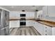 Modern kitchen featuring white cabinets, wood countertops, stainless steel appliances, and modern flooring at , Las Vegas, NV 89139