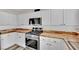 Bright kitchen featuring stainless steel appliances, white cabinets, and butcher block countertops at , Las Vegas, NV 89139